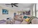 Relaxing living room featuring a large sectional sofa and kitchen view at 11928 Frost Aster Dr, Riverview, FL 33579