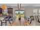Dining room with large wooden table and sliding glass doors leading to backyard at 11928 Frost Aster Dr, Riverview, FL 33579