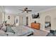Bright bedroom with king bed, dresser, and view of bathroom at 11928 Frost Aster Dr, Riverview, FL 33579