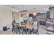 Bright dining area adjacent to kitchen, featuring a large wooden table at 11928 Frost Aster Dr, Riverview, FL 33579