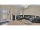 Spacious living room with large sectional sofa and tile floors at 11928 Frost Aster Dr, Riverview, FL 33579
