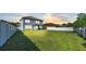 Large grassy backyard with a view of the house's back elevation at 11928 Frost Aster Dr, Riverview, FL 33579