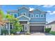Two-story house with gray exterior, brown garage door, and lush landscaping at 11928 Frost Aster Dr, Riverview, FL 33579