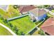 Aerial view of a home's backyard with a large lawn and white fence at 11928 Frost Aster Dr, Riverview, FL 33579