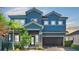 Stunning two-story house with a blue exterior and a three-car garage at 11928 Frost Aster Dr, Riverview, FL 33579