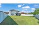 Expansive backyard featuring a large grassy area and a two-story house at 11928 Frost Aster Dr, Riverview, FL 33579
