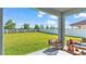 Spacious backyard with grassy lawn, patio furniture, and covered patio at 11928 Frost Aster Dr, Riverview, FL 33579