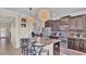 Open kitchen with island, stainless steel appliances, and breakfast bar seating at 11928 Frost Aster Dr, Riverview, FL 33579