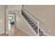Elegant staircase with wrought iron railing and carpeted steps at 11928 Frost Aster Dr, Riverview, FL 33579