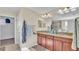 Double vanity bathroom with granite countertop and large mirror at 11928 Frost Aster Dr, Riverview, FL 33579