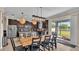 Open dining room with kitchen access and large farmhouse table at 11928 Frost Aster Dr, Riverview, FL 33579