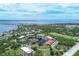 Aerial view showing community near the waterfront with a pond and surrounding landscape at 23465 Harborview Rd # 734, Punta Gorda, FL 33980