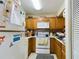 Small kitchen with wood cabinets and appliances at 2625 State Road 590 # 124, Clearwater, FL 33759