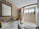 Clean bathroom with tub shower, vanity, and window at 2625 State Road 590 # 124, Clearwater, FL 33759