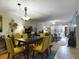 Dining room with yellow chairs and view of living room at 2625 State Road 590 # 124, Clearwater, FL 33759