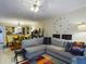 Living room with sectional sofa and access to dining area at 2625 State Road 590 # 124, Clearwater, FL 33759