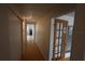 Hallway with light wood floors and doors to other rooms at 6702 71St N Ave, Pinellas Park, FL 33781