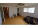 Bedroom with wood-look floors, ceiling fan, and access to other rooms at 6702 71St N Ave, Pinellas Park, FL 33781