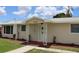 Tan house with white trim, walkway, and landscaping at 6702 71St N Ave, Pinellas Park, FL 33781
