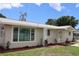 Tan house with a landscaped yard and palm tree at 6702 71St N Ave, Pinellas Park, FL 33781