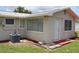 Side of house with A/C unit and landscaping at 6702 71St N Ave, Pinellas Park, FL 33781