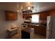 Bright kitchen with wood cabinets, island, and pot rack at 6702 71St N Ave, Pinellas Park, FL 33781