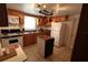 Bright kitchen with wood cabinets, island, and pot rack at 6702 71St N Ave, Pinellas Park, FL 33781