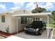 Carport next to house with a black car parked at 6702 71St N Ave, Pinellas Park, FL 33781
