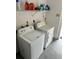 Functional laundry area equipped with a washing machine and dryer, featuring convenient shelving for storage at 24 Quails Run Blvd # 3, Englewood, FL 34223