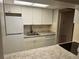 White kitchen cabinets and granite countertops at 24 Quails Run Blvd # 3, Englewood, FL 34223