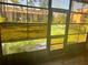 Bright screened patio overlooking green space at 24 Quails Run Blvd # 3, Englewood, FL 34223