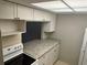 Bright kitchen with white cabinets and granite countertops at 24 Quails Run Blvd # 3, Englewood, FL 34223