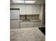 Kitchen with white cabinets and granite countertops at 24 Quails Run Blvd # 3, Englewood, FL 34223