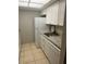 Kitchen with white cabinets, granite counters, and appliances at 24 Quails Run Blvd # 3, Englewood, FL 34223