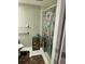 Bathroom with shower, grab bar, and decorative curtain at 24 Quails Run Blvd # 3, Englewood, FL 34223