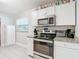 Well-equipped kitchen with granite counters and white cabinets at 1512 E Shadowlawn Ave, Tampa, FL 33610