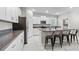 Modern kitchen with stainless steel appliances and an island with seating at 9681 Flourish Dr, Land O Lakes, FL 34637