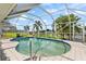 Refreshing kidney-shaped pool with screened enclosure overlooking canal at 272 E Tarpon Nw Blvd, Port Charlotte, FL 33952