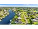 Aerial view of canal-front home in a residential neighborhood at 272 E Tarpon Nw Blvd, Port Charlotte, FL 33952