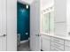 Bathroom with teal feature wall and white vanity at 5330 Silver Sun Dr, Apollo Beach, FL 33572
