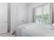 Guest bedroom with double doors to closet and window with blinds at 5330 Silver Sun Dr, Apollo Beach, FL 33572