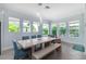 Light and airy dining room with a large table and access to pool views at 5330 Silver Sun Dr, Apollo Beach, FL 33572