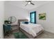 Cozy bedroom with a full-size bed, teal accents, and a convenient workspace at 5330 Silver Sun Dr, Apollo Beach, FL 33572