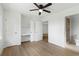 Bedroom with hardwood floors, built-in shelving, and en-suite bathroom at 13065 Via Aurelia, Placida, FL 33946