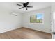 Light-filled bedroom with hardwood floors and a window with garden view at 13065 Via Aurelia, Placida, FL 33946