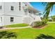 Side view of the house showcasing the stairs and landscaping at 13065 Via Aurelia, Placida, FL 33946