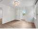 Bright bedroom with wood-look floors, chandelier, and window at 13065 Via Aurelia, Placida, FL 33946