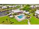 Community pool with surrounding lounge chairs and landscaping at 13065 Via Aurelia, Placida, FL 33946