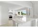Bright white kitchen with stainless steel appliances and quartz countertops at 13065 Via Aurelia, Placida, FL 33946