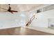 Bright living area with high ceilings and a wooden staircase at 13065 Via Aurelia, Placida, FL 33946